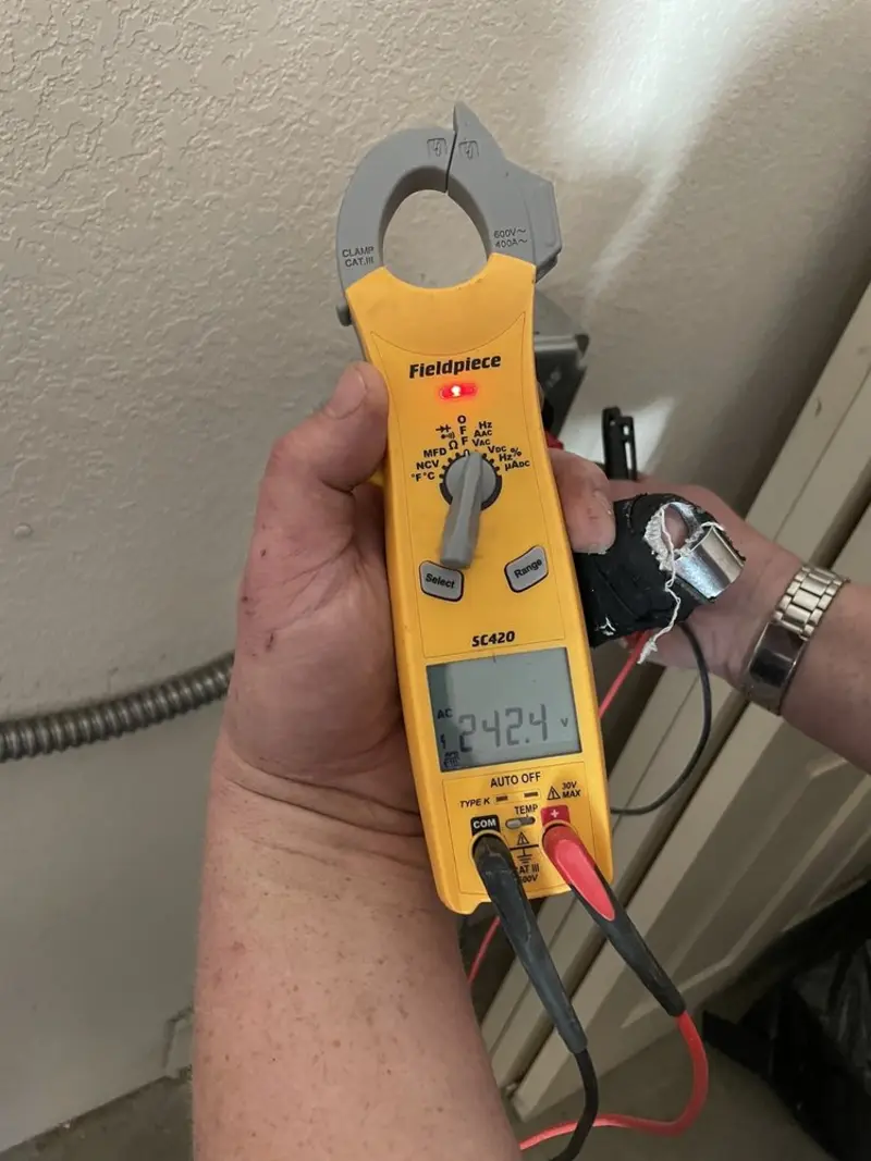 Voltage testing with clamp meter during Generator Installation in Deerfield Beach